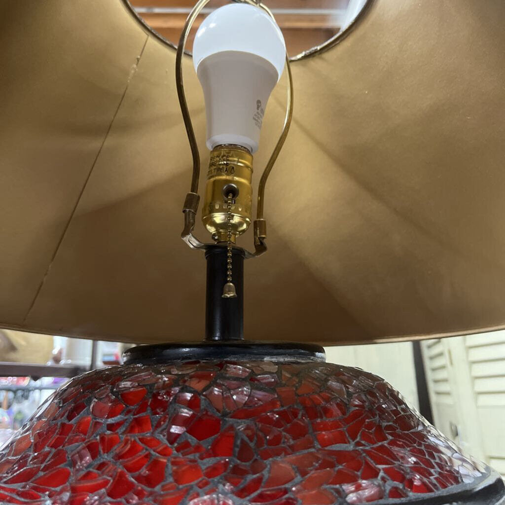 TABLE LAMP FEATURES A RED MOSAIC-TILED BASE, AND A CONICAL BLACK FABRIC LAMP SHADE