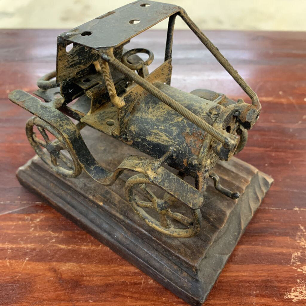 OLD IRON CAR ON WOOD