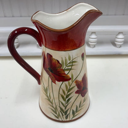 Hand-painted ceramic pitcher with red flowers