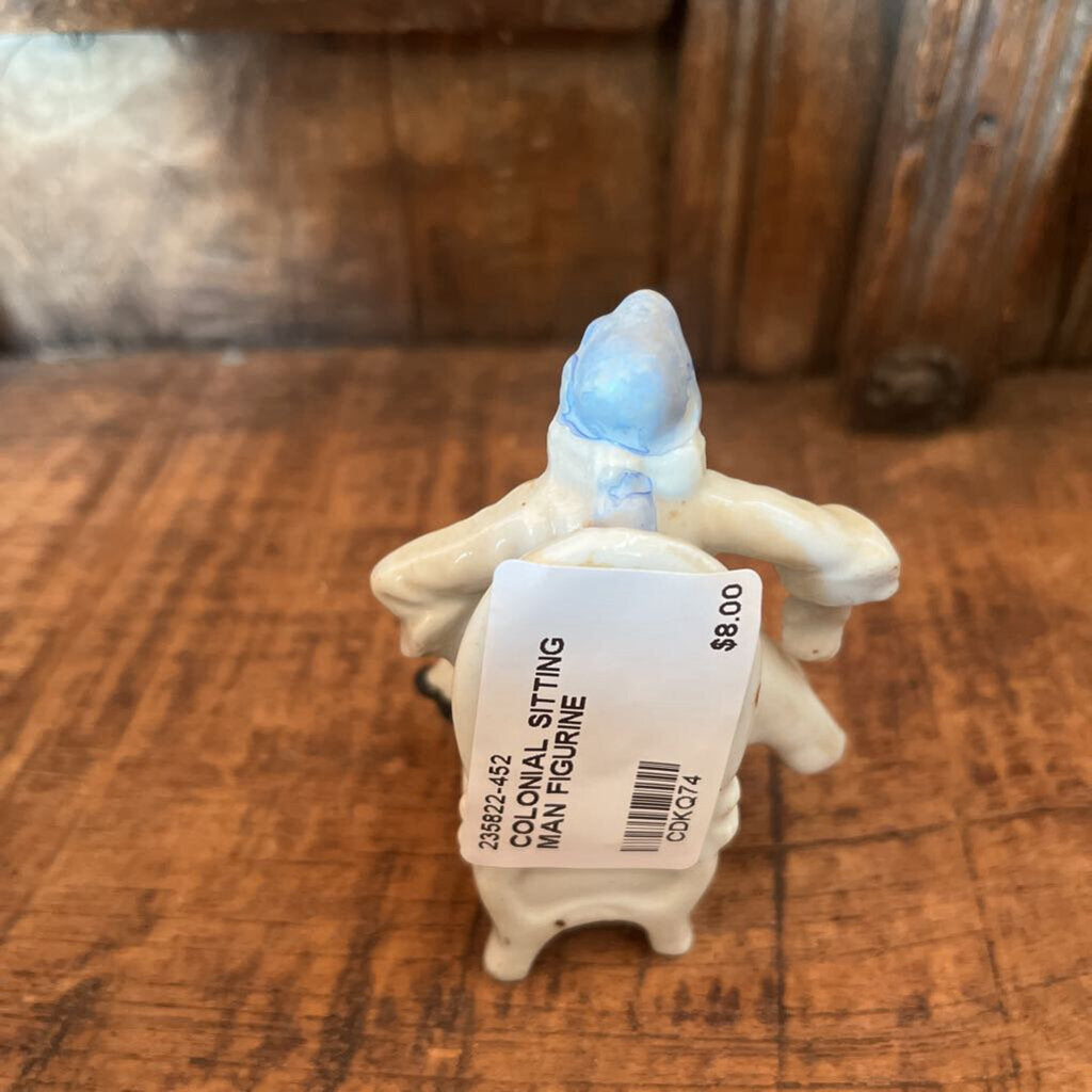 COLONIAL SITTING MAN FIGURINE