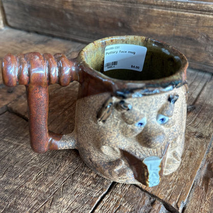 Pottery face mug