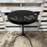 ROUND BLACK OUTDOOR TABLE WITH DECORATIVE CUTOUT DESIGN