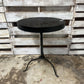 ROUND BLACK OUTDOOR TABLE WITH DECORATIVE CUTOUT DESIGN