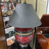 TABLE LAMP FEATURES A RED MOSAIC-TILED BASE, AND A CONICAL BLACK FABRIC LAMP SHADE